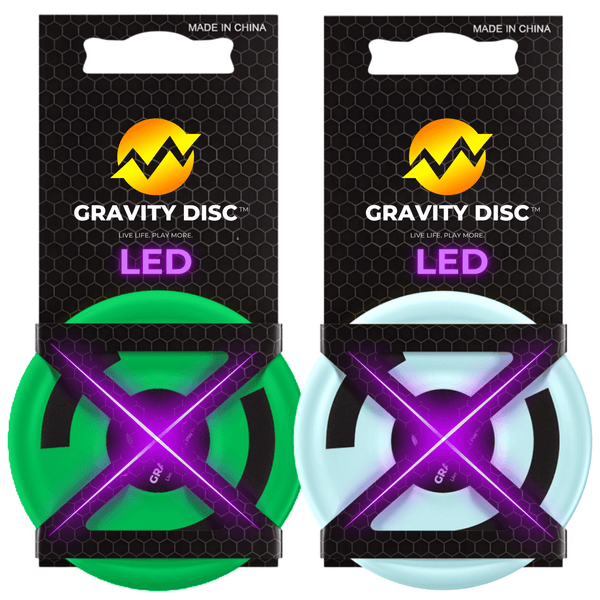 Glow-in-the-dark Gravity Disc mini flying toy shown mid-air with neon light trail, perfect for kids, teens, and outdoor nighttime games - Bundle pack of two NightFlight discs